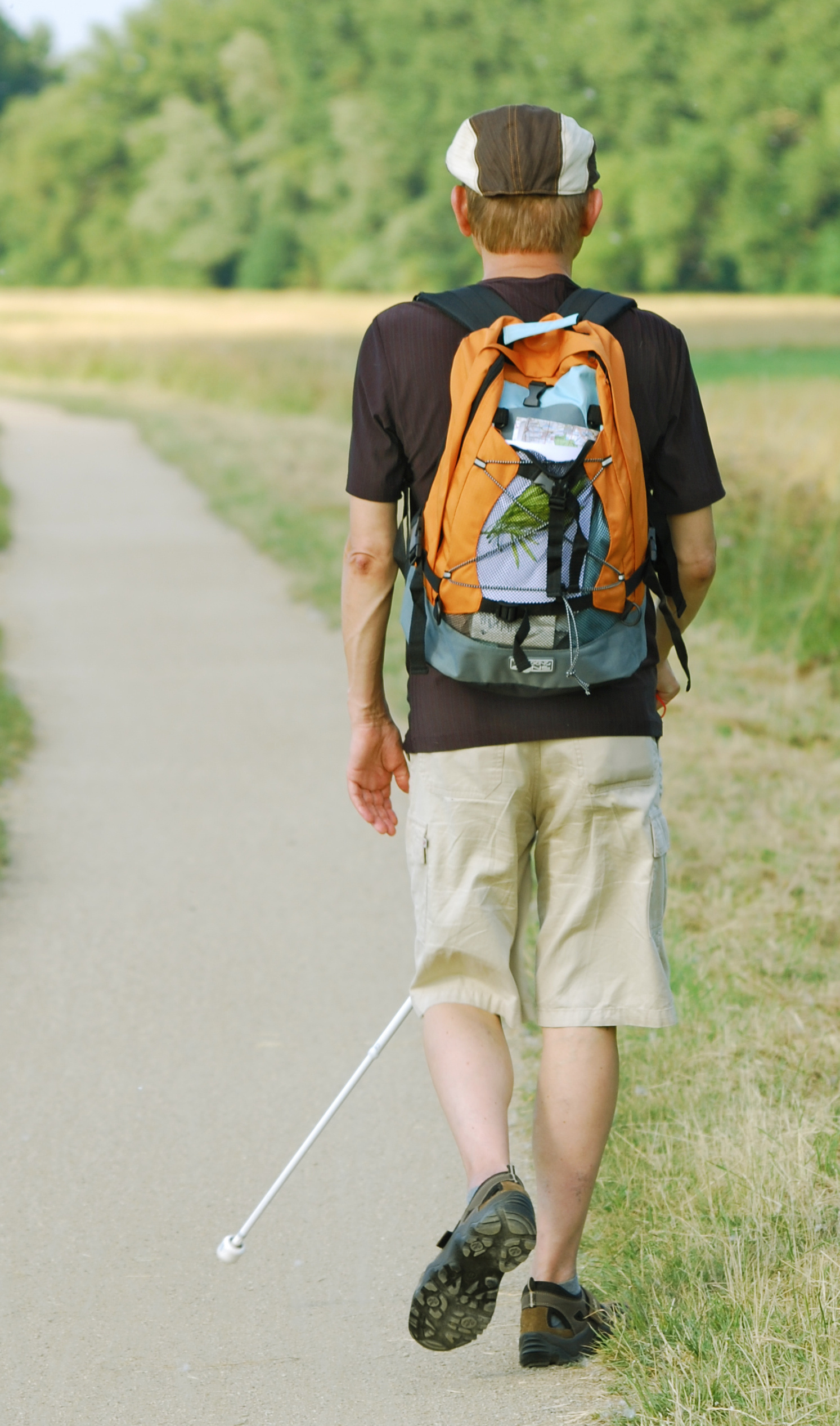 Person hiking with a white cane