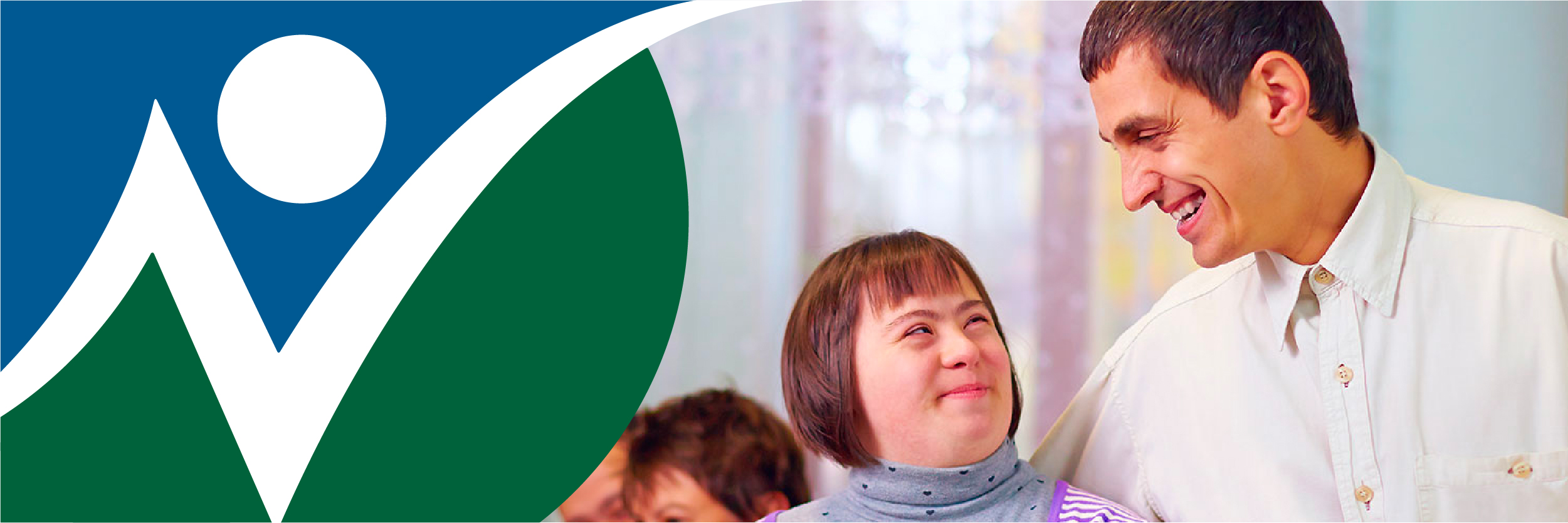 NNCIL logo next to photo of a male teacher with a young woman with a cognitive disability
