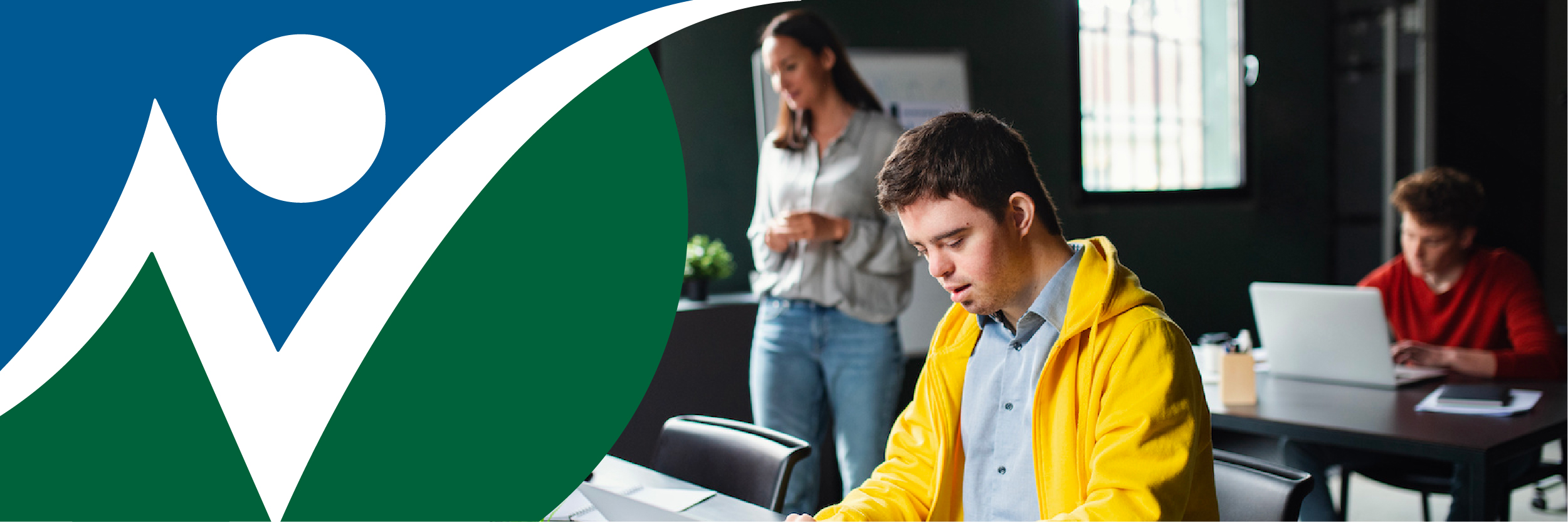 NNCIL logo next to a photo of a young man with a cognitive disability learning how to work on a computer, with others behind him.